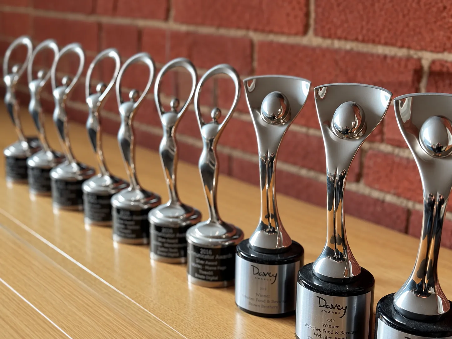 A row of Communicator Awards and Davey Awards won by Emote Digital.